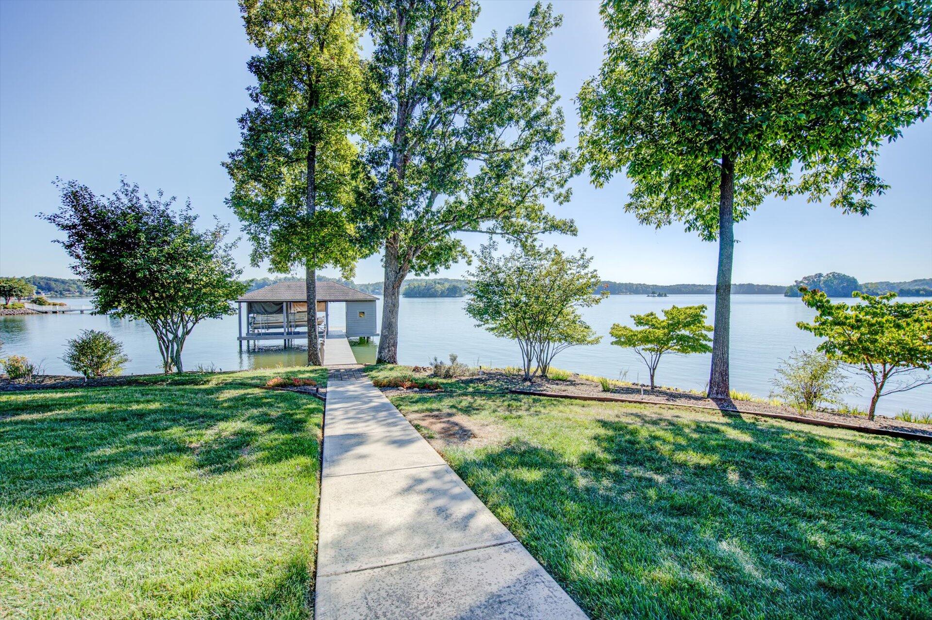 249 Pine Bay Drive Union Hall, VA 24176 - Photo 48 of 62 a view of a patio with table and chairs and potted plants and large trees