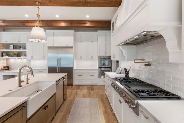 a kitchen with a sink cabinets and wooden floor