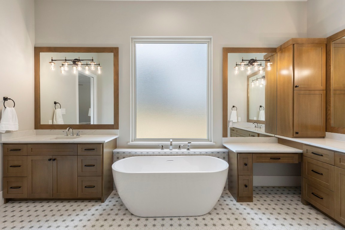 27318 Blue Cedar Lane Spring, TX 77386 - Photo 19 of 45 Spa-inspired bathroom with freestanding soaking tub, expansive vanity, oversized mirror, and glass walk-in shower.