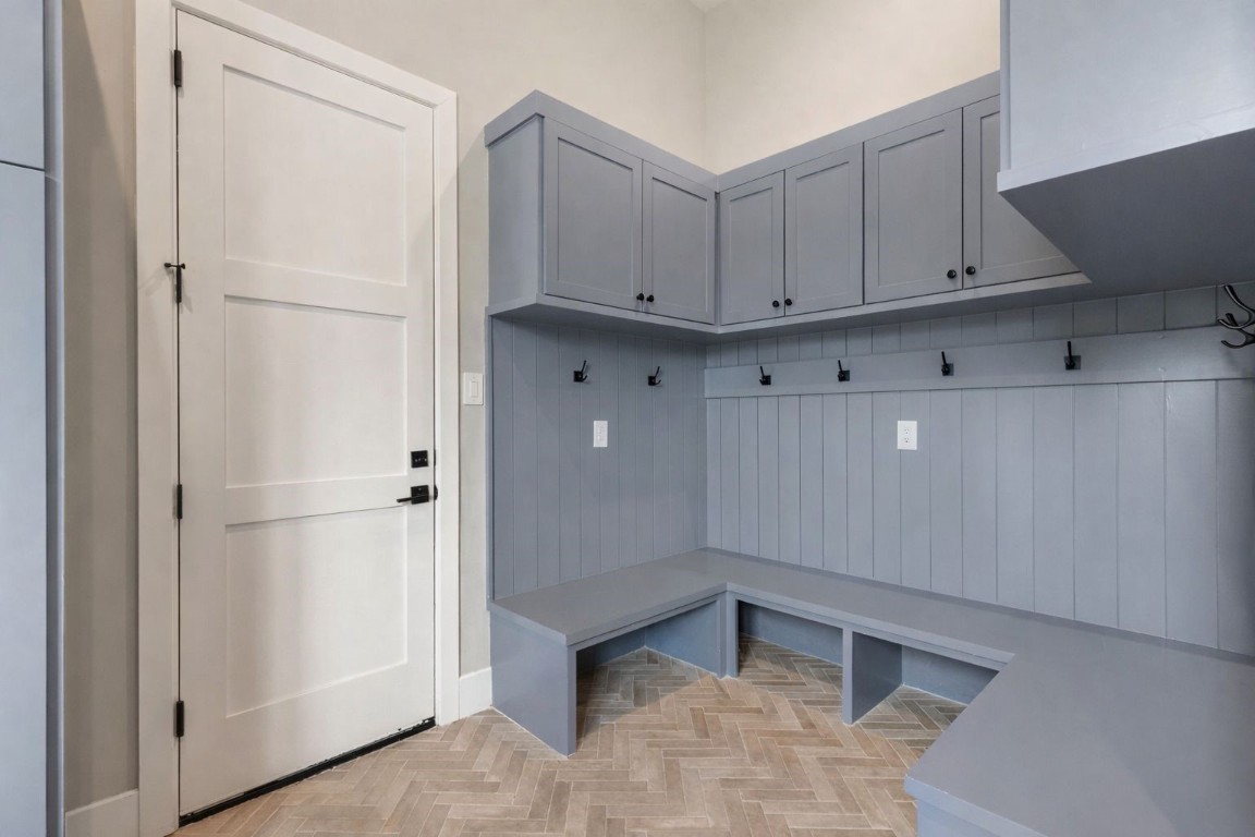 27318 Blue Cedar Lane Spring, TX 77386 - Photo 22 of 45 Stylish mudroom with built-in bench seating, cubbies, and upper cabinets over durable tile flooring.