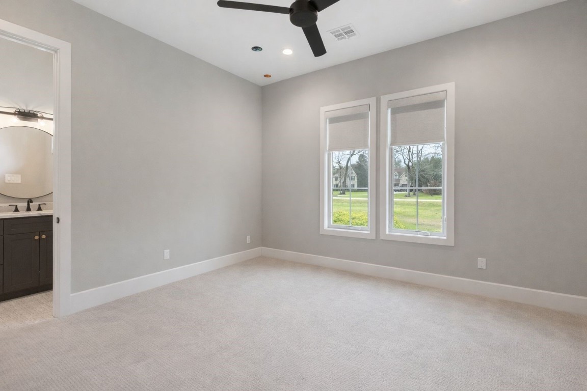 27318 Blue Cedar Lane Spring, TX 77386 - Photo 30 of 45 Serene bedroom with soaring ceilings, modern ceiling fan, and twin windows for abundant natural light.