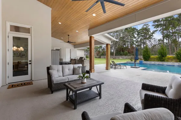 a view of a house with swimming pool and sitting area