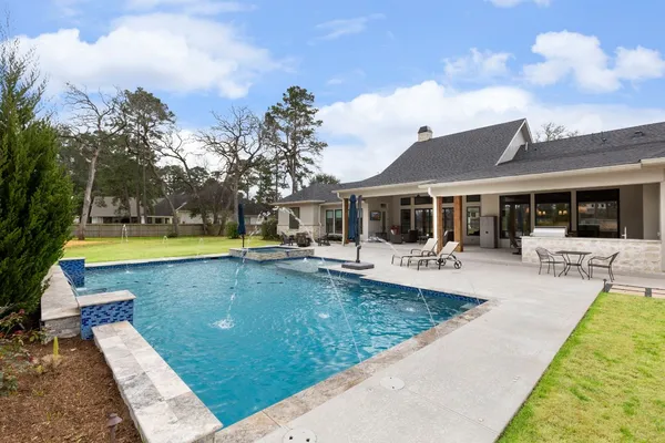 an aerial view of a pool with a table and chairs