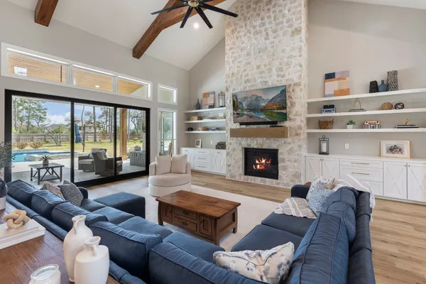 a living room with furniture large window and a fireplace
