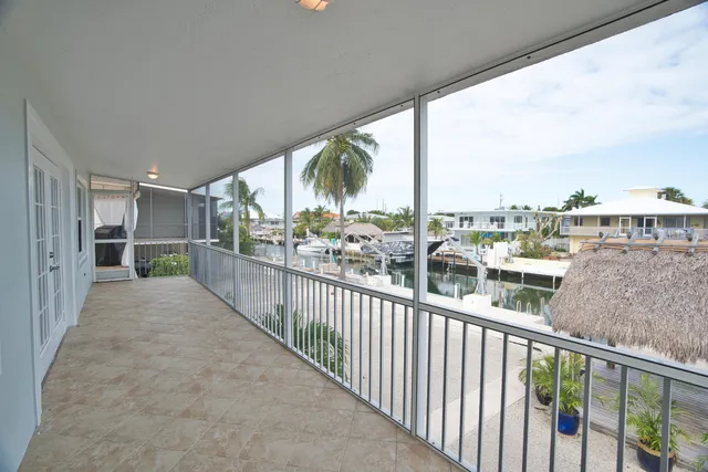 a large kitchen with kitchen island granite countertop a table and chairs in it