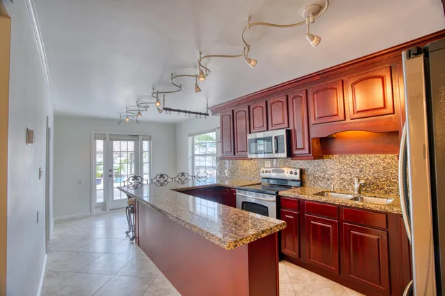 a view of a porch with furniture and potted plants