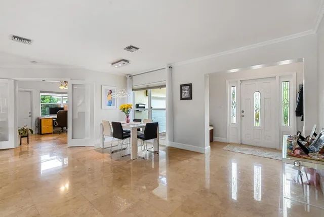 a view of a livingroom with furniture and an entryway