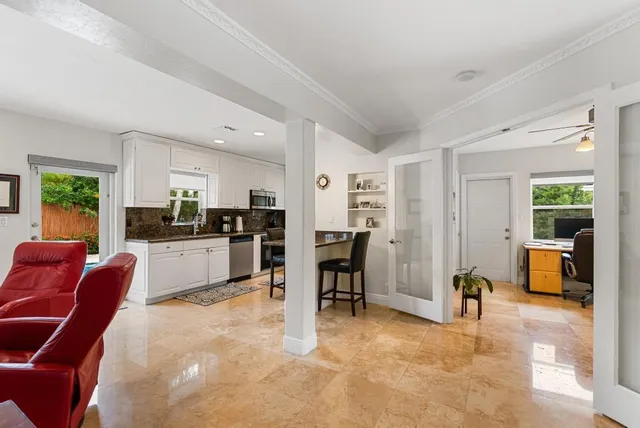 a living room with furniture a dining table and kitchen view