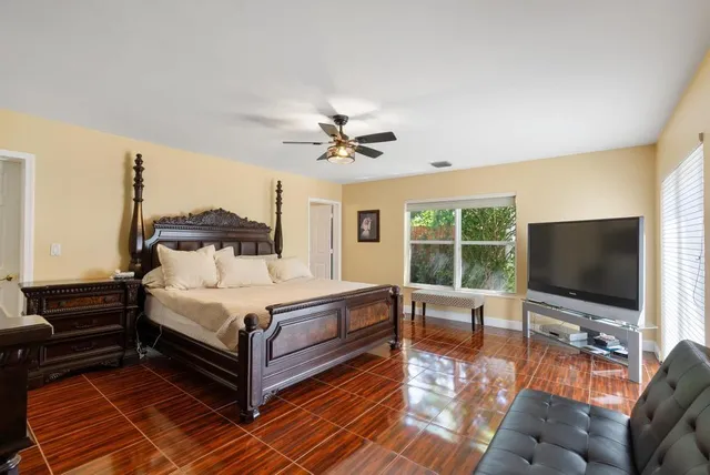 a bedroom with a bed and a flat screen tv