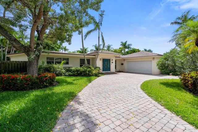 a front view of a house with a garden and plants