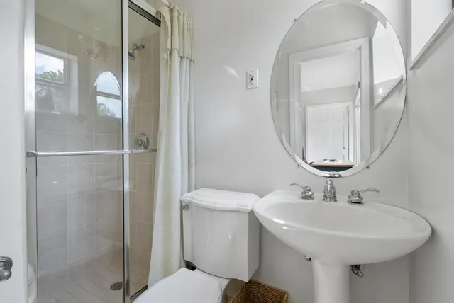 a bathroom with a sink toilet and shower