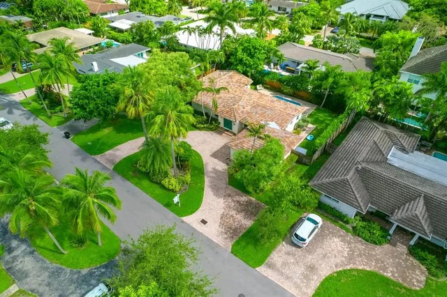 an aerial view of a house with garden space and street view