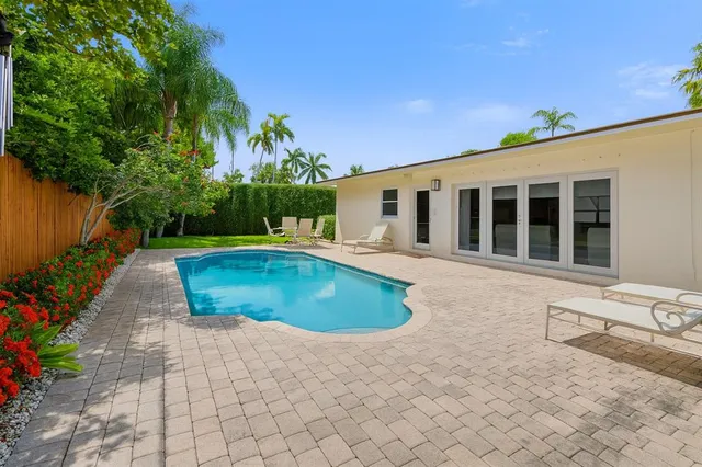 a view of a house with swimming pool and sitting area