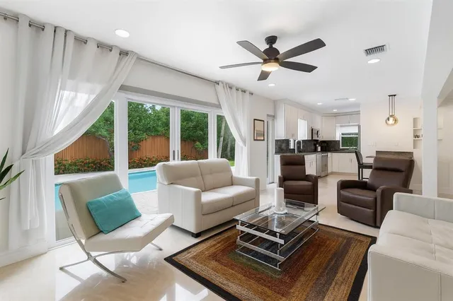 a living room with furniture and a large window