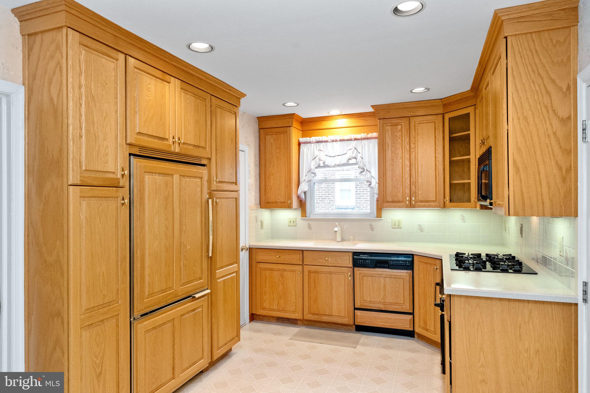411 Buse Street Ridley Park, PA 19078 - Photo 11 of 30 a kitchen with cabinets and wooden floor