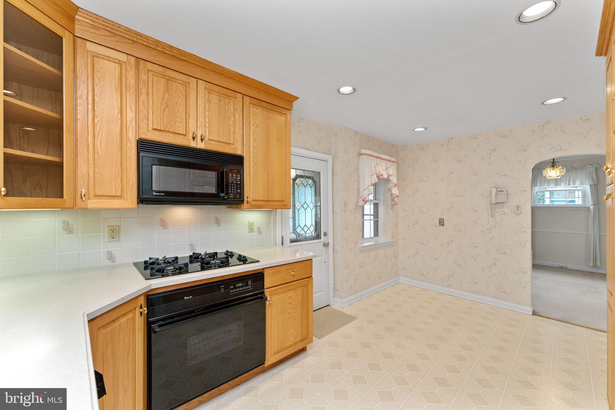 411 Buse Street Ridley Park, PA 19078 - Photo 13 of 30 a kitchen with stainless steel appliances granite countertop a stove a sink and a microwave