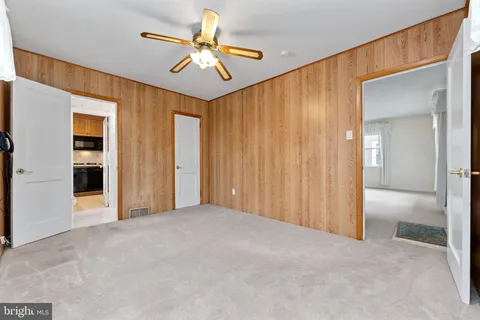 an empty room with windows and closet