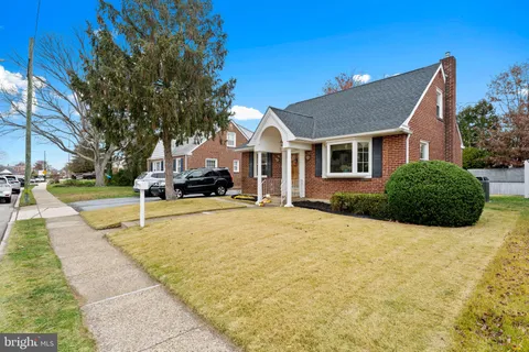 a house that has a tree in front of it