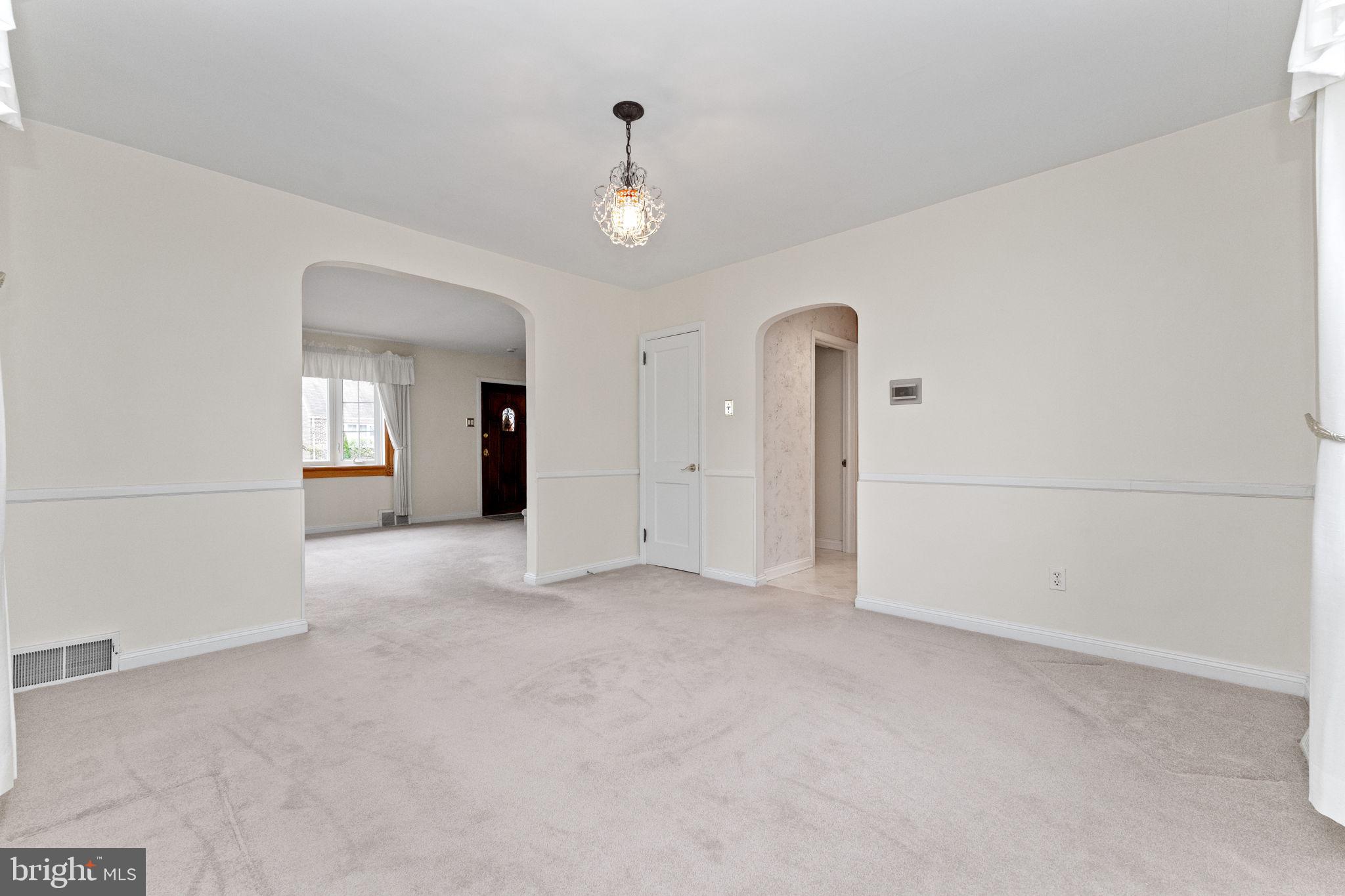 411 Buse Street Ridley Park, PA 19078 - Photo 8 of 30 an empty room with chandelier fan and windows