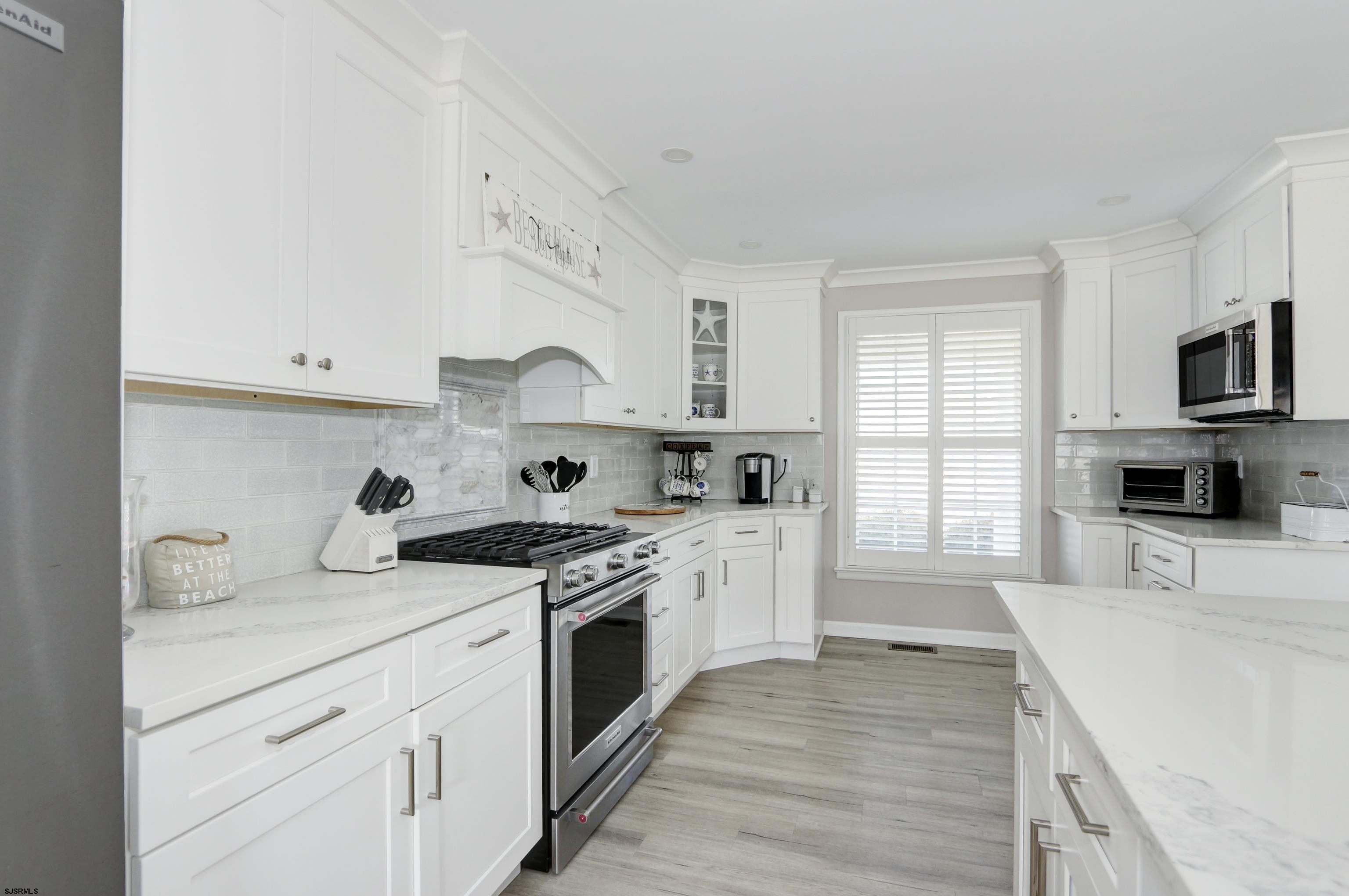 9 Sunset Boulevard Egg Harbor Township, NJ 08403 - Photo 11 of 60 a kitchen with stainless steel appliances granite countertop a sink and a stove