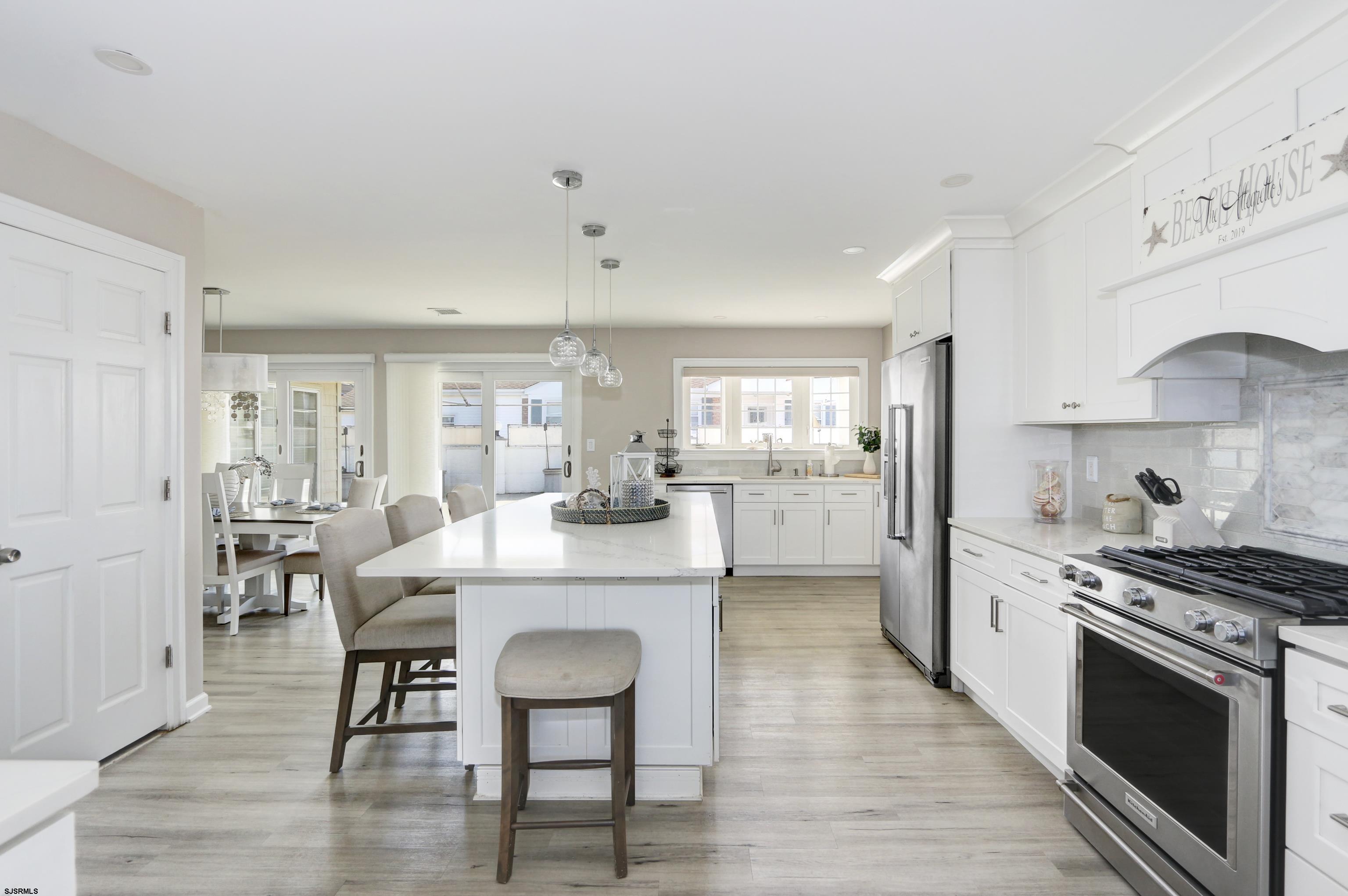 9 Sunset Boulevard Egg Harbor Township, NJ 08403 - Photo 12 of 60 a kitchen with kitchen island a stove a table and chairs in it