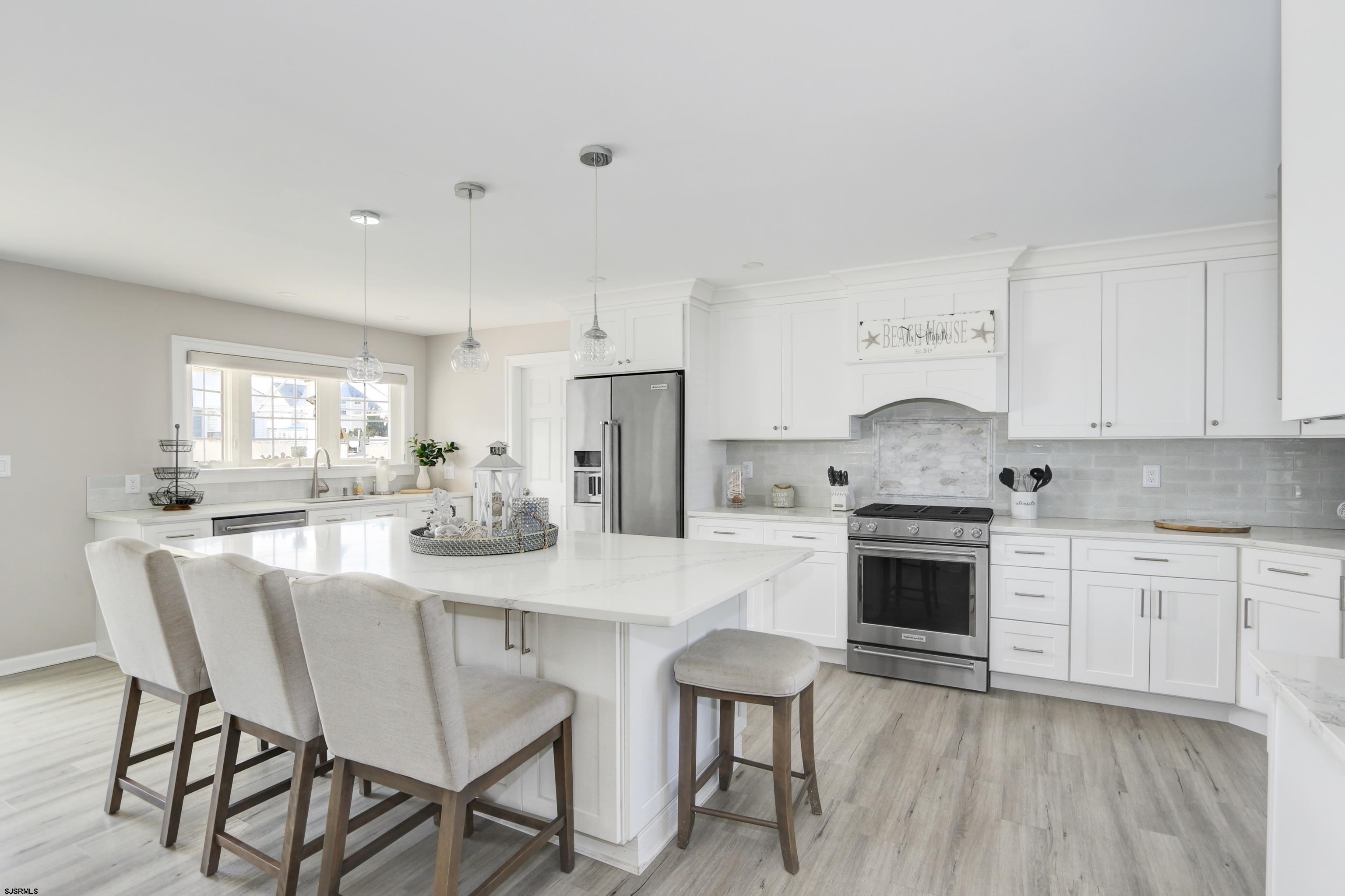 9 Sunset Boulevard Egg Harbor Township, NJ 08403 - Photo 13 of 60 a kitchen with granite countertop a stove top oven microwave and cabinets