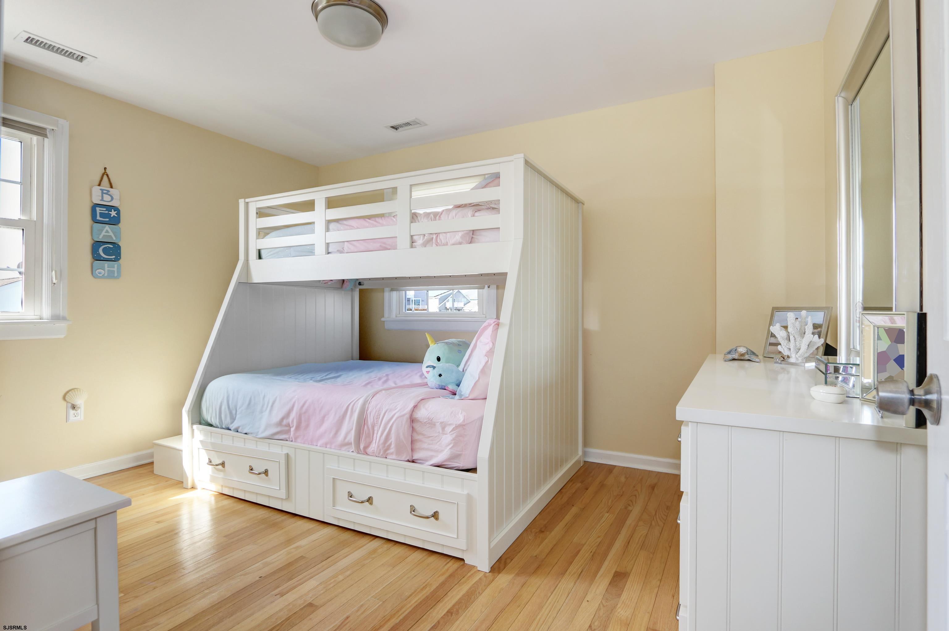 9 Sunset Boulevard Egg Harbor Township, NJ 08403 - Photo 21 of 60 a bedroom with a bed and wooden floor