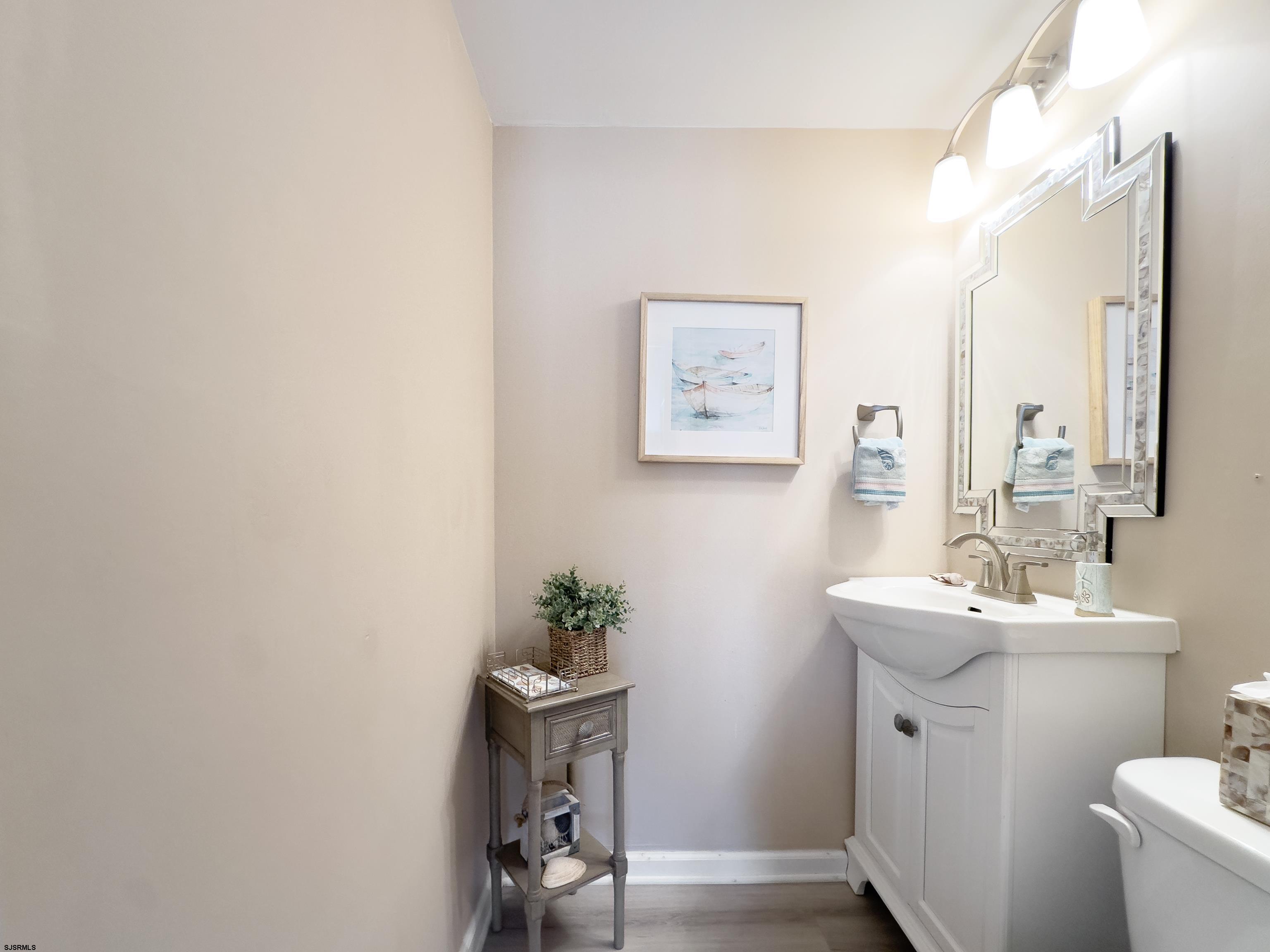 9 Sunset Boulevard Egg Harbor Township, NJ 08403 - Photo 24 of 60 a bathroom with a sink a mirror and a toilet