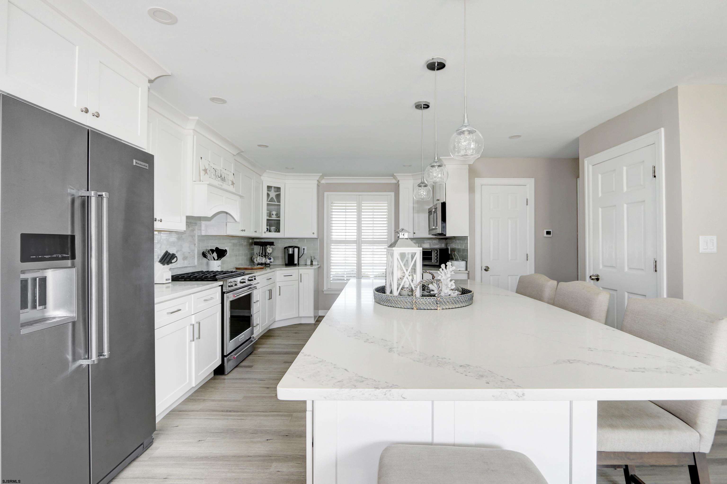 9 Sunset Boulevard Egg Harbor Township, NJ 08403 - Photo 10 of 60 a kitchen with granite countertop a sink stove refrigerator and white cabinets