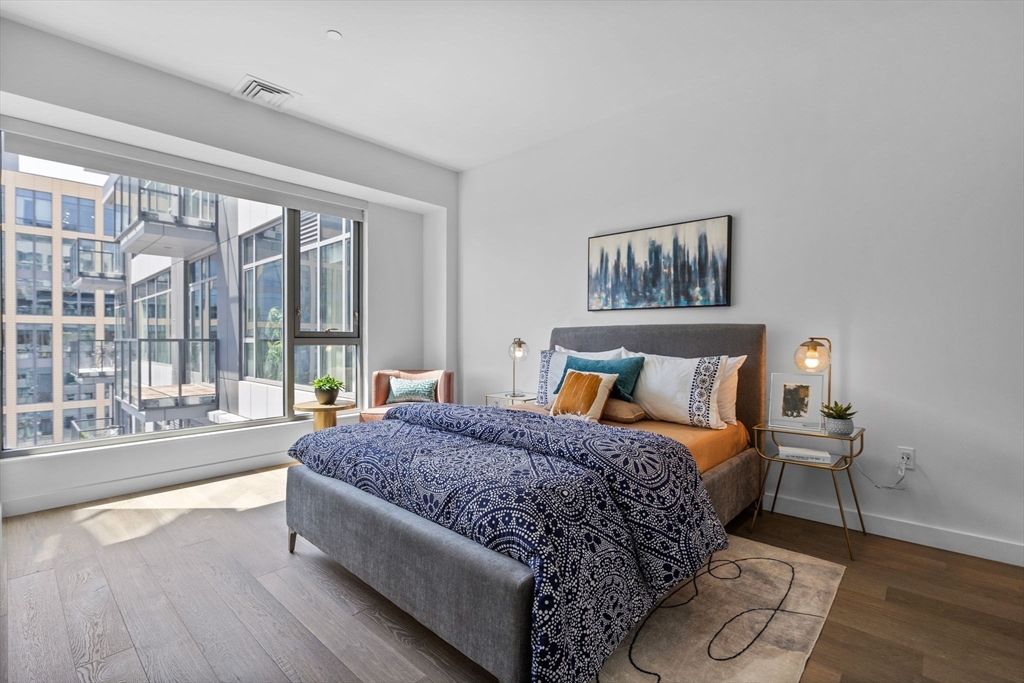 375 Canal Street, Unit PH101 Somerville, MA 02145 - Photo 13 of 39 a spacious bedroom with a bed and glass walk in closet