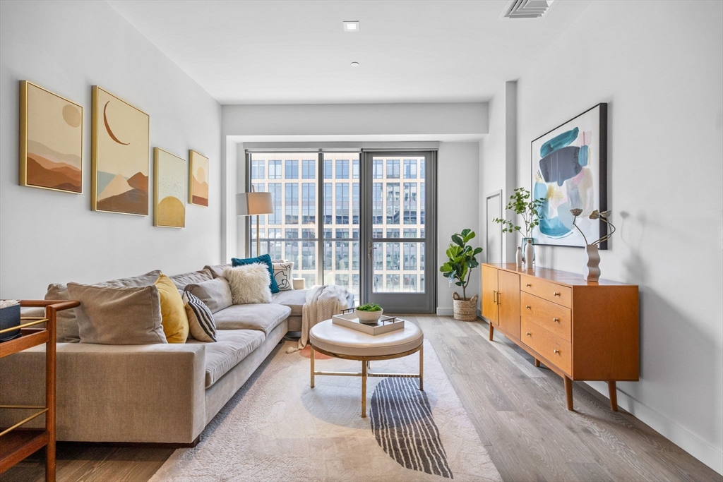 375 Canal Street, Unit PH101 Somerville, MA 02145 - Photo 3 of 39 a living room with furniture and a large window