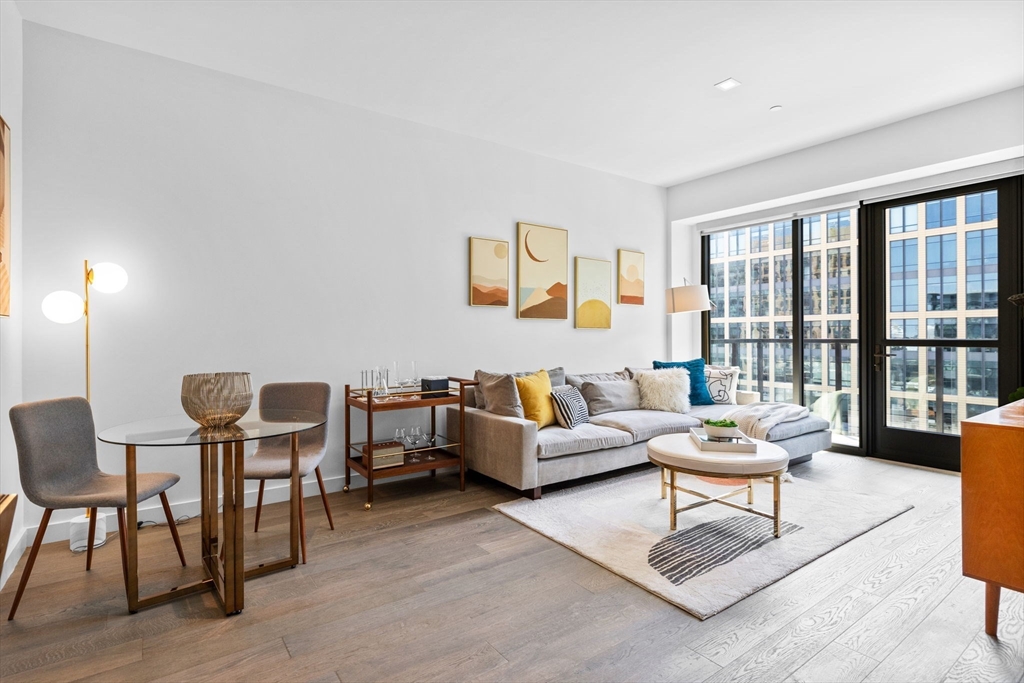 375 Canal Street, Unit PH101 Somerville, MA 02145 - Photo 5 of 39 a living room with furniture and a floor to ceiling window