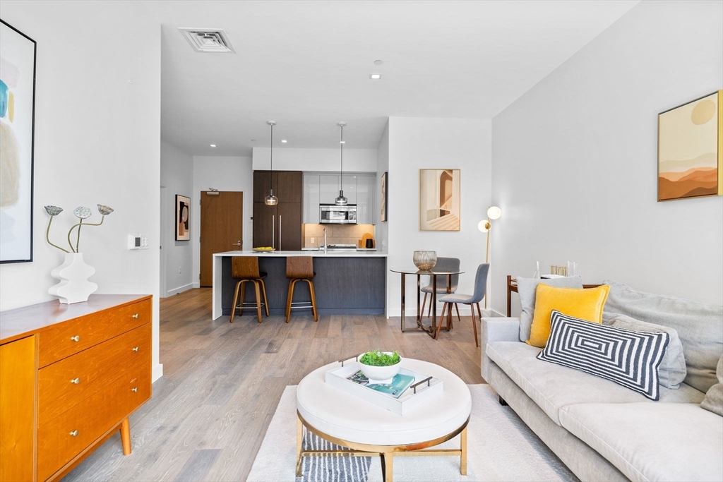 375 Canal Street, Unit PH101 Somerville, MA 02145 - Photo 6 of 39 a living room with furniture and wooden floor