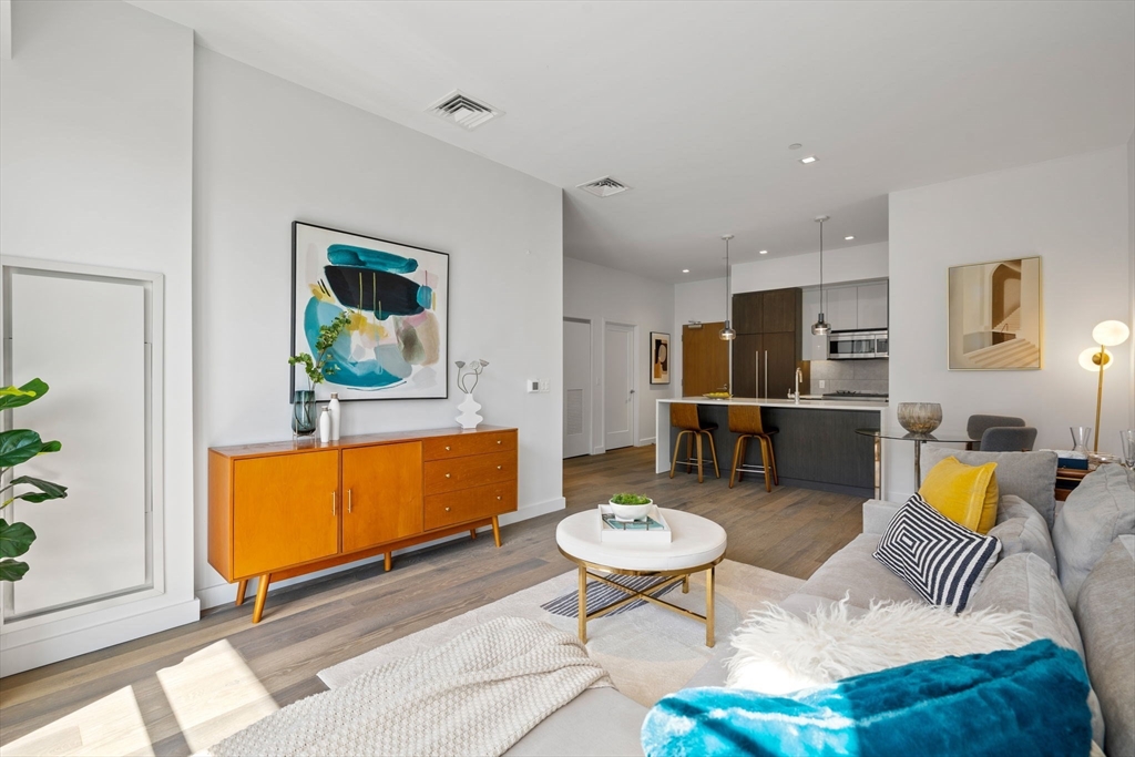 375 Canal Street, Unit PH101 Somerville, MA 02145 - Photo 7 of 39 a living room with furniture and a dining table with garden view