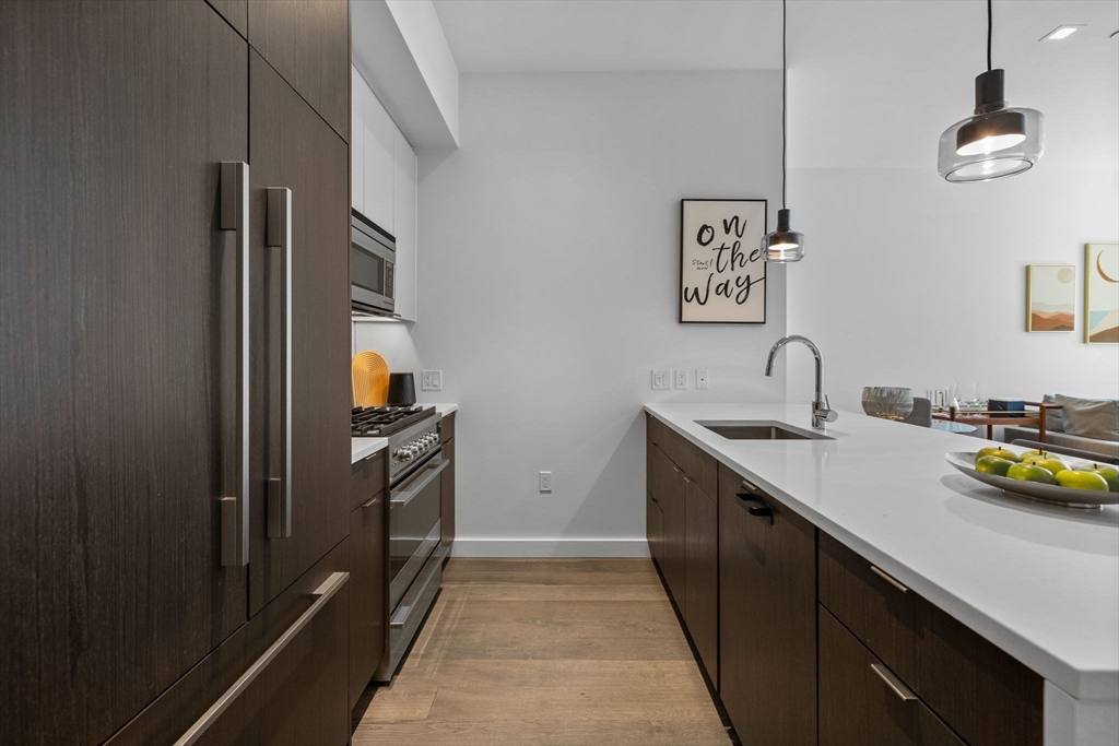 375 Canal Street, Unit PH101 Somerville, MA 02145 - Photo 10 of 39 a kitchen with a sink and stainless steel appliances