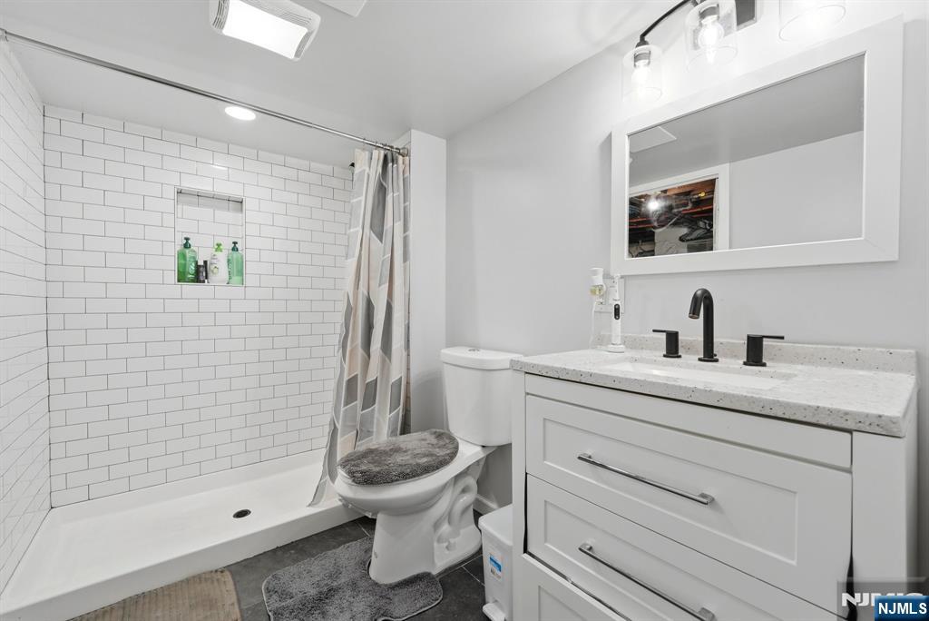 44 Alpine Place Kearny, NJ 07032 - Photo 42 of 50 a bathroom with a sink a toilet and shower