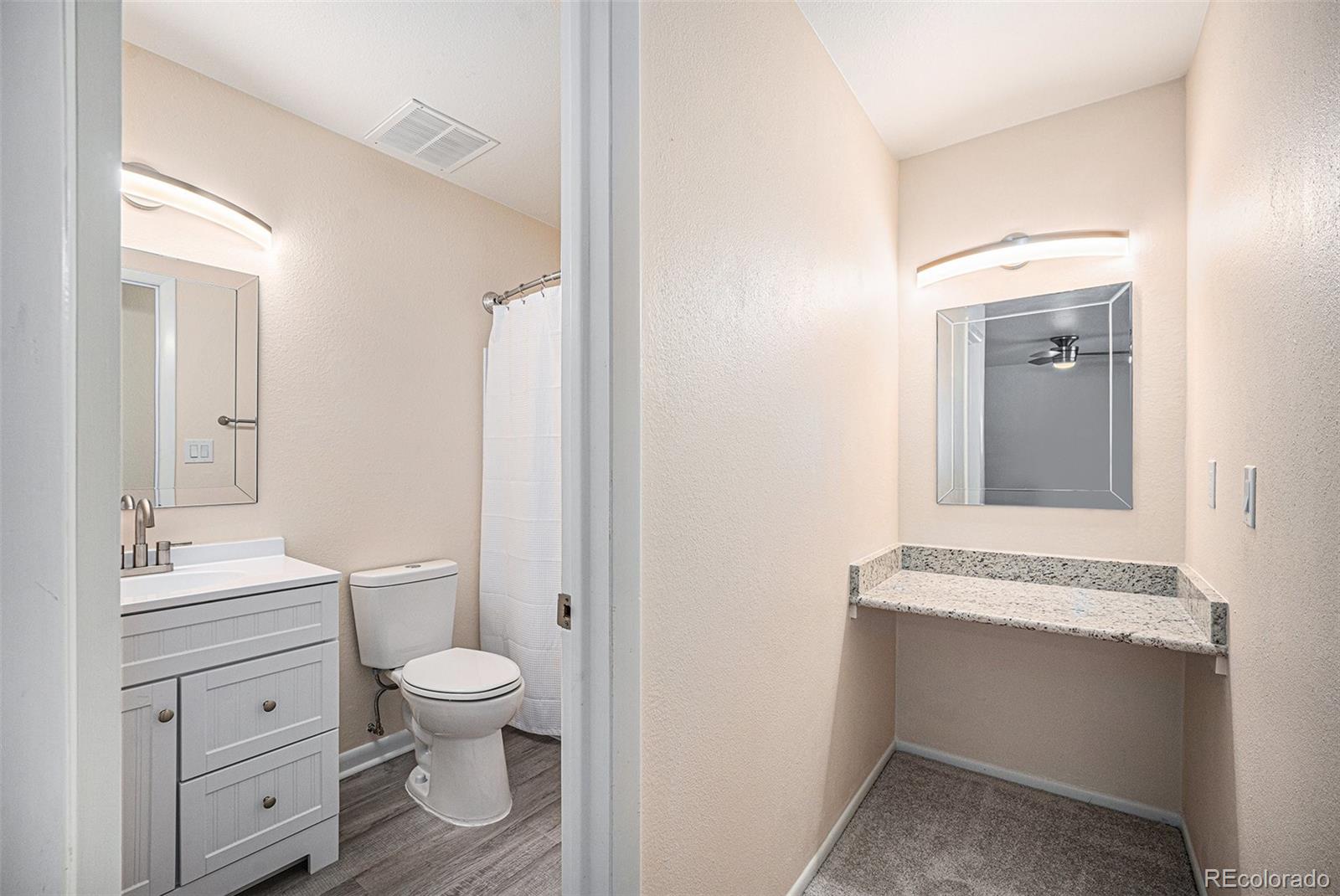 1830 Simms Street Lakewood, CO 80215 - Photo 15 of 31 a bathroom with a sink a toilet and a mirror