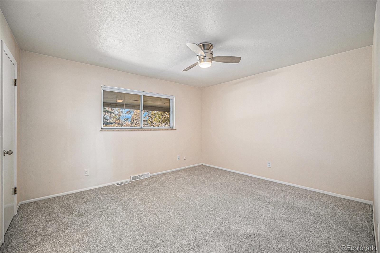 1830 Simms Street Lakewood, CO 80215 - Photo 17 of 31 an empty room with a window and ceiling fan