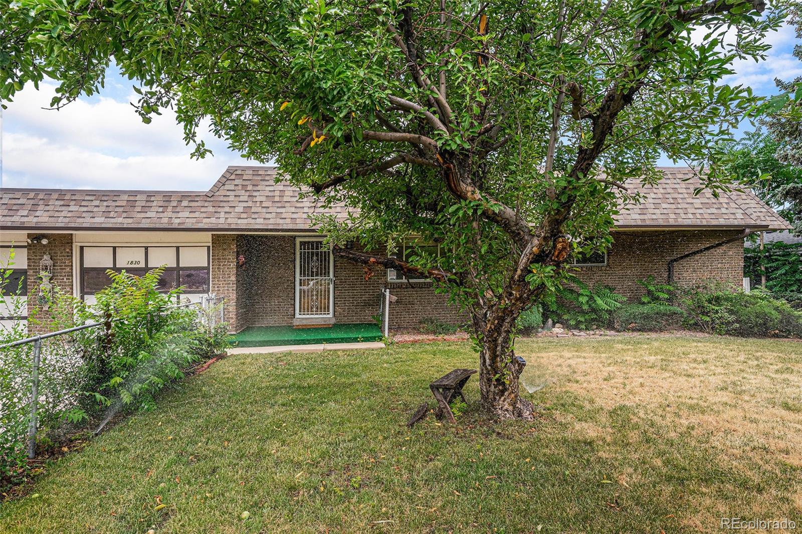 1830 Simms Street Lakewood, CO 80215 - Photo 29 of 31 a front view of a house with garden