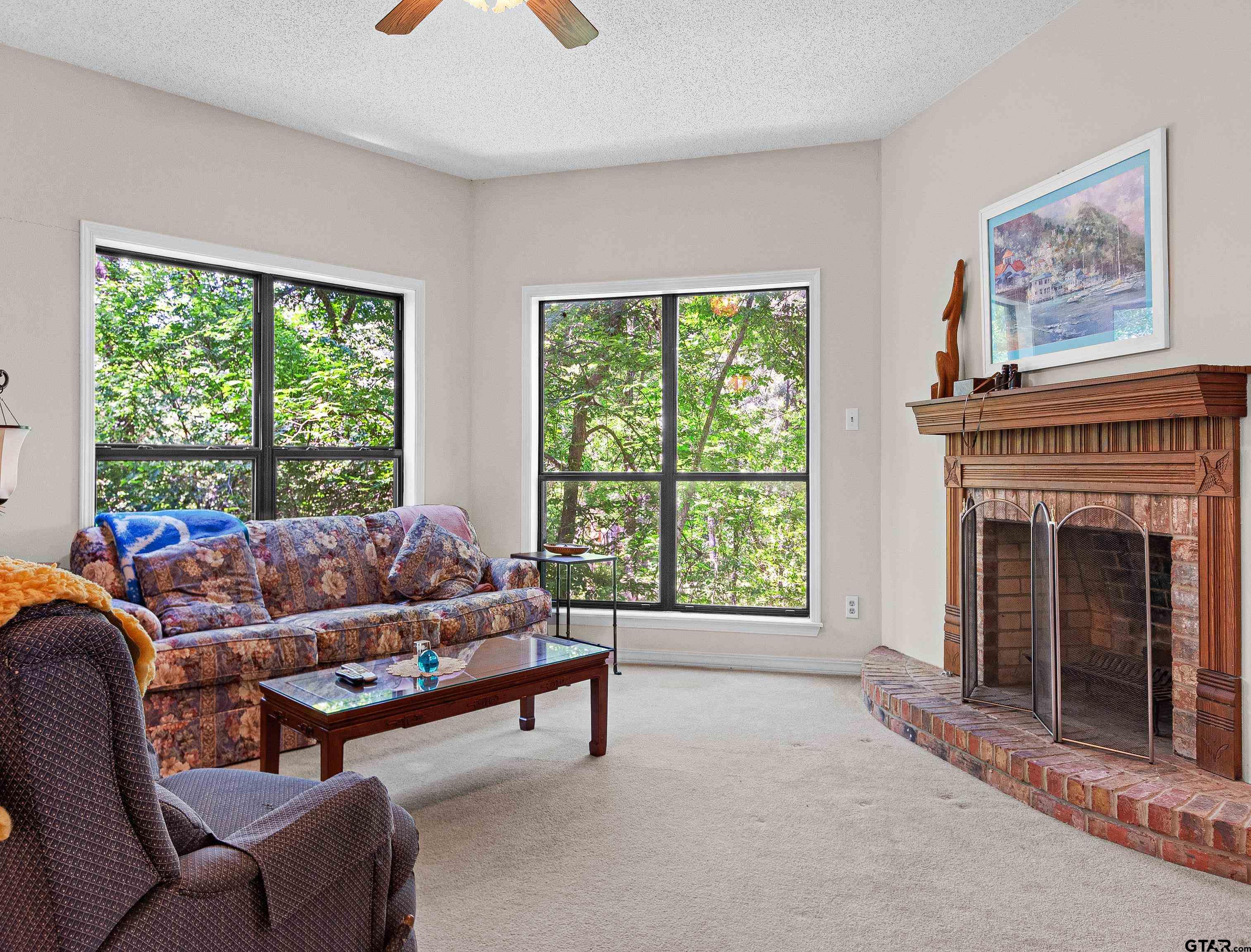18862 Big Timber Road Tyler, TX 75703 - Photo 12 of 33 a living room with furniture and a fireplace