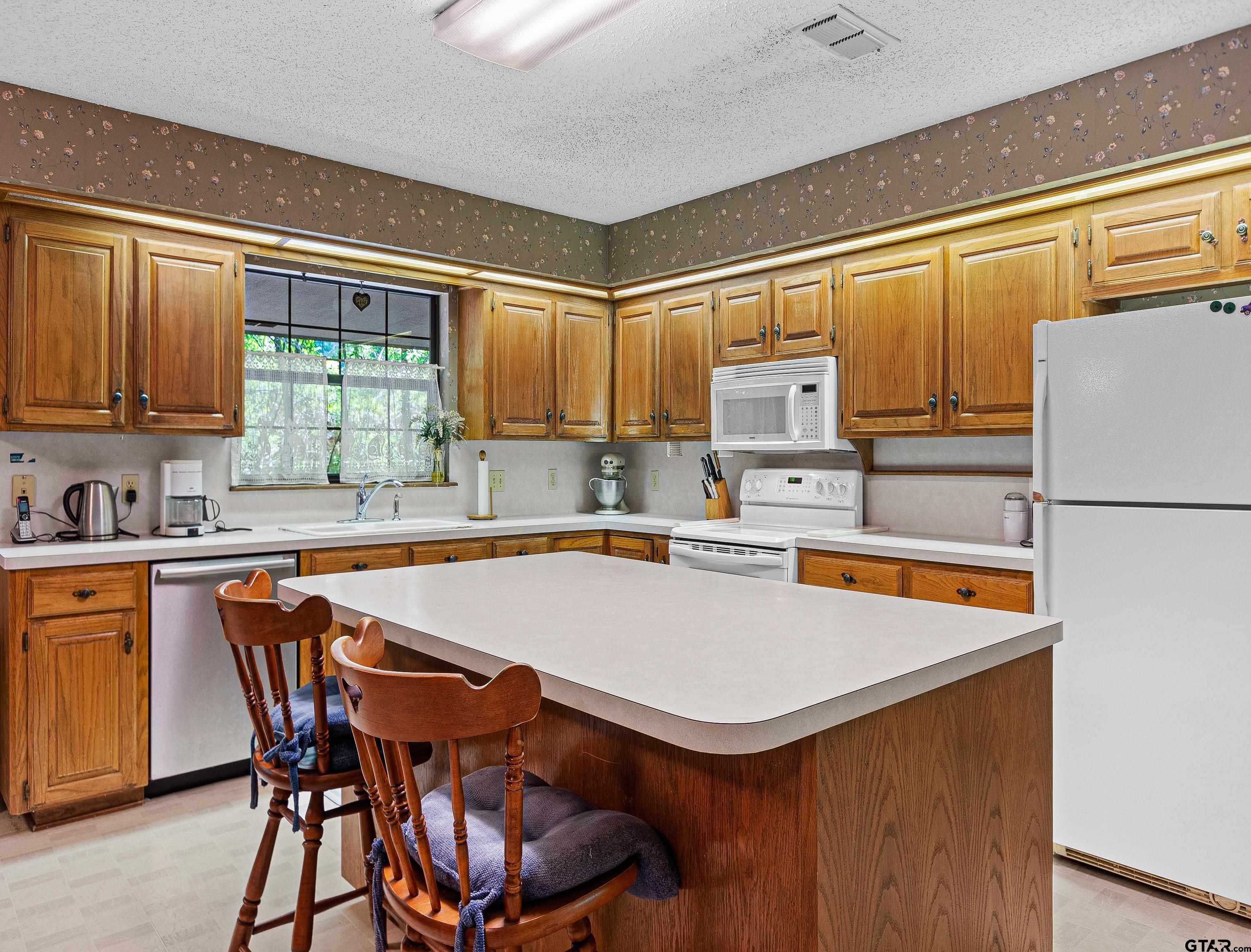 18862 Big Timber Road Tyler, TX 75703 - Photo 13 of 33 a kitchen with a sink a stove and cabinets