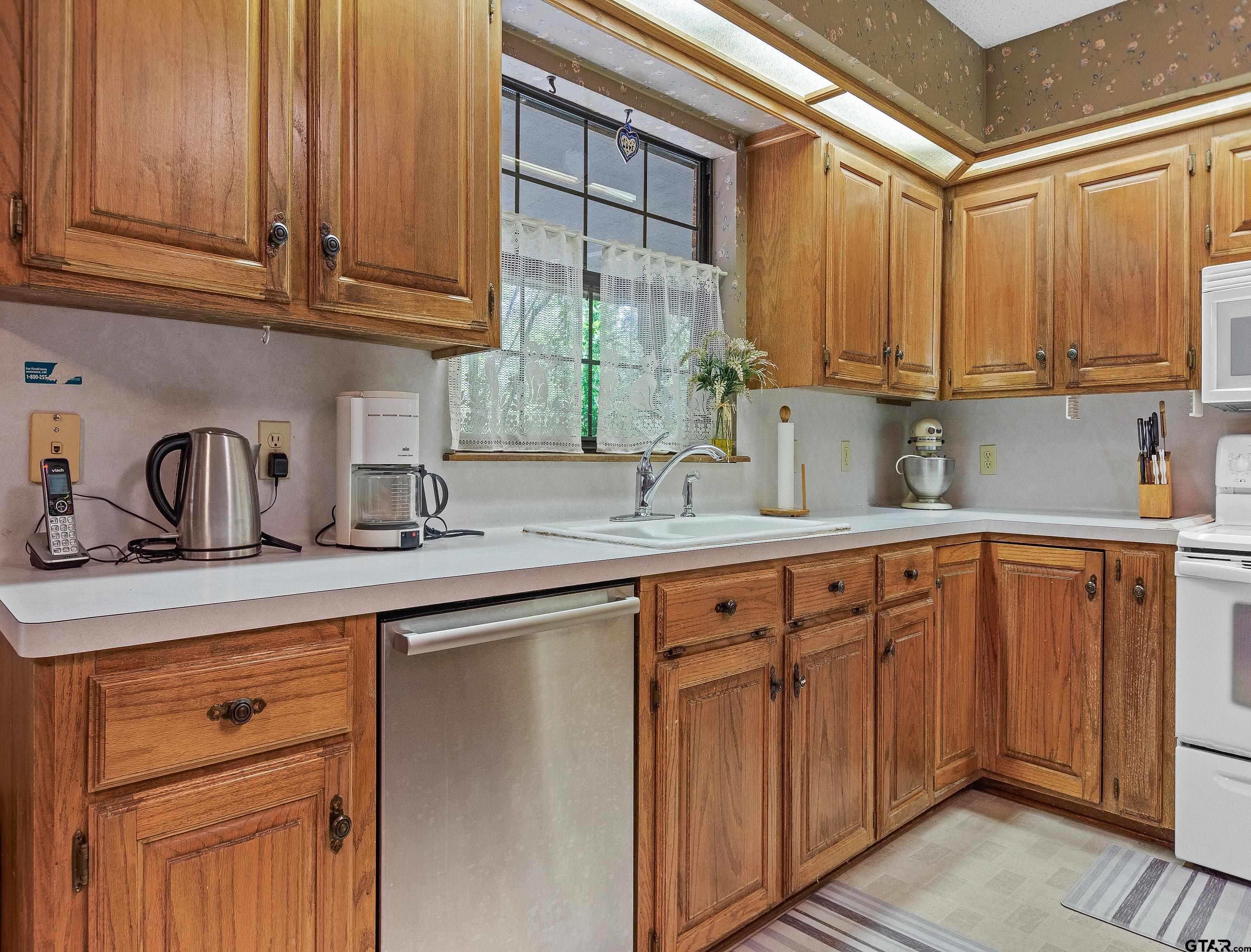18862 Big Timber Road Tyler, TX 75703 - Photo 14 of 33 a kitchen with stainless steel appliances granite countertop a sink and cabinets