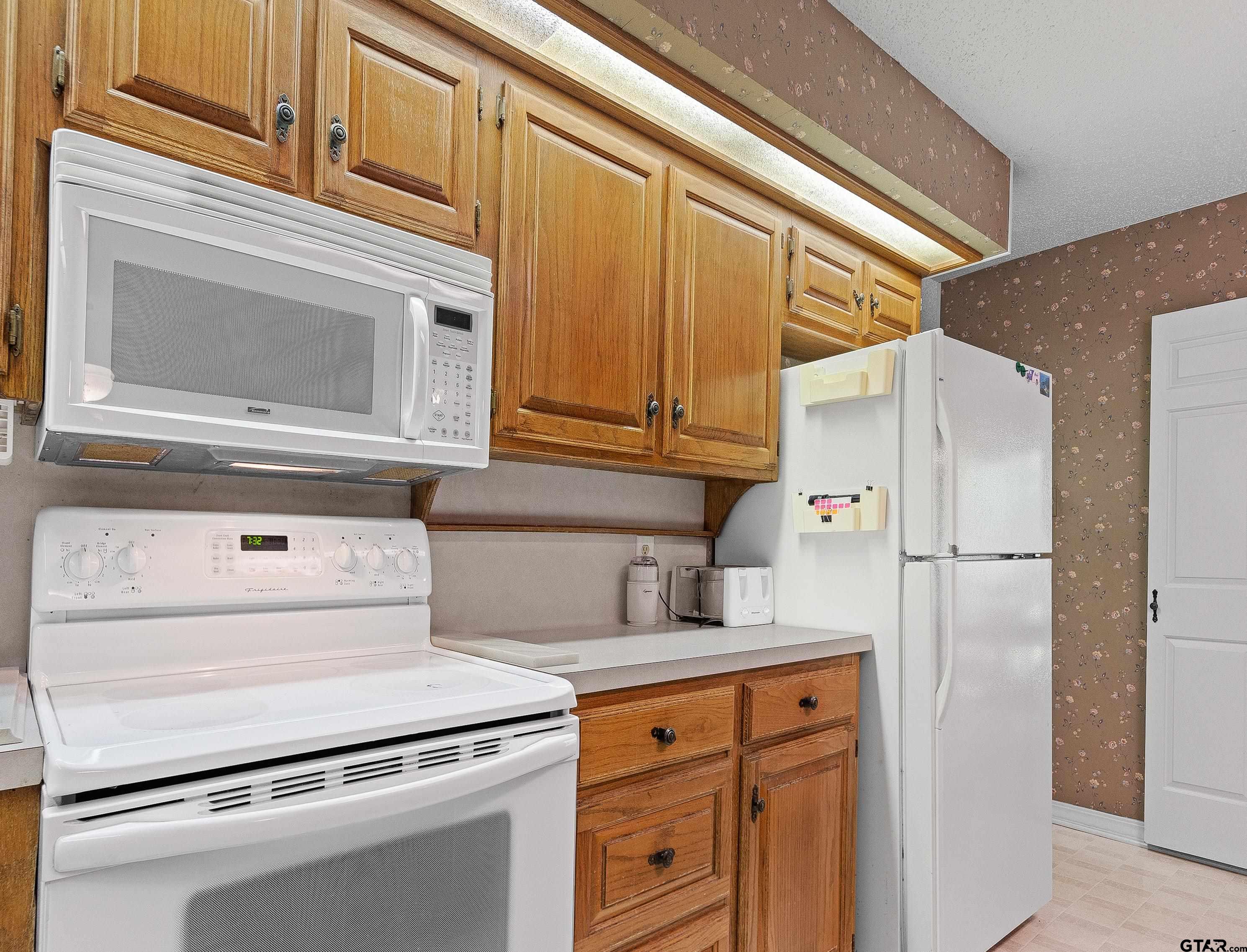 18862 Big Timber Road Tyler, TX 75703 - Photo 15 of 33 a kitchen with stainless steel appliances cabinets and a refrigerator