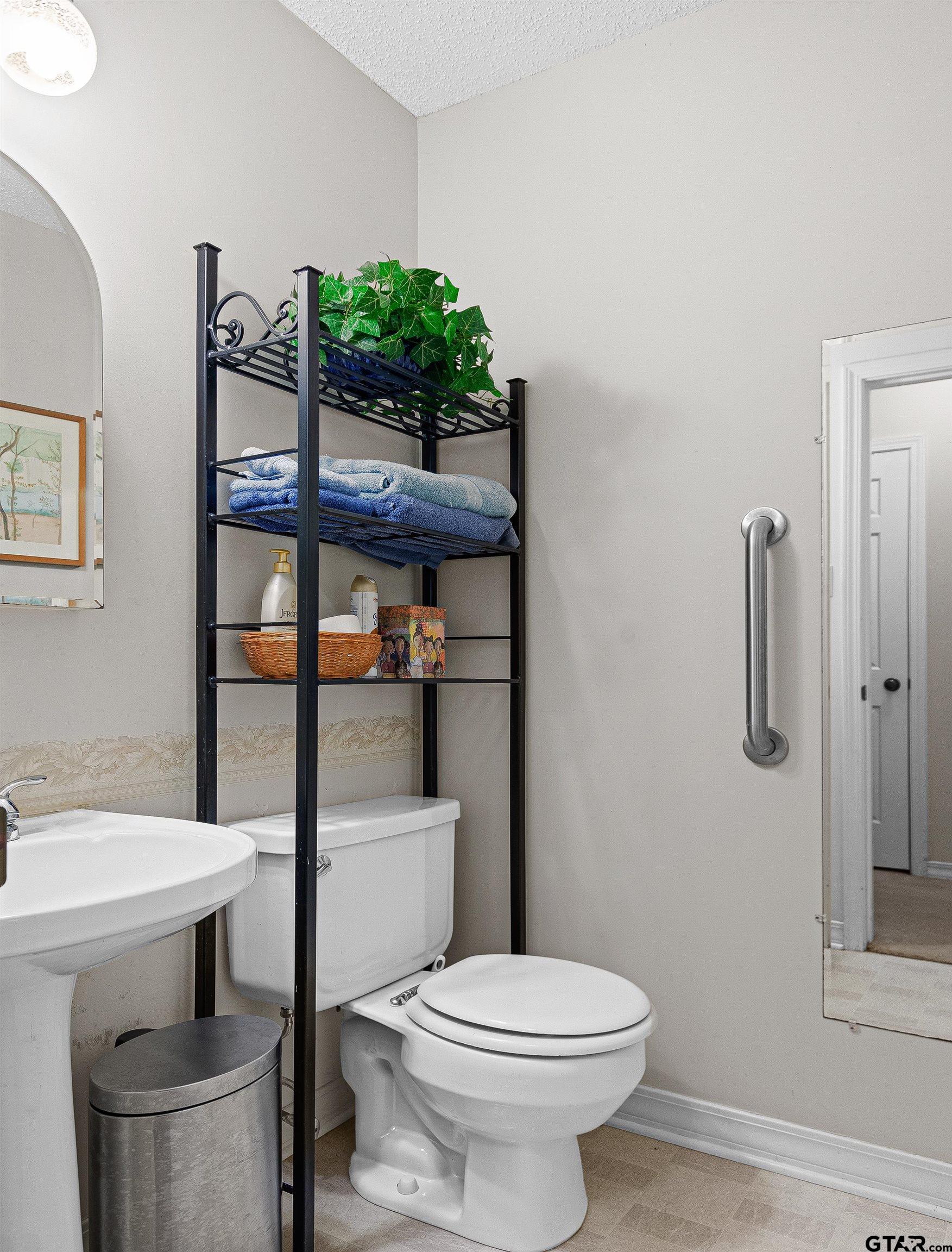 18862 Big Timber Road Tyler, TX 75703 - Photo 19 of 33 a bathroom with a toilet sink and shower