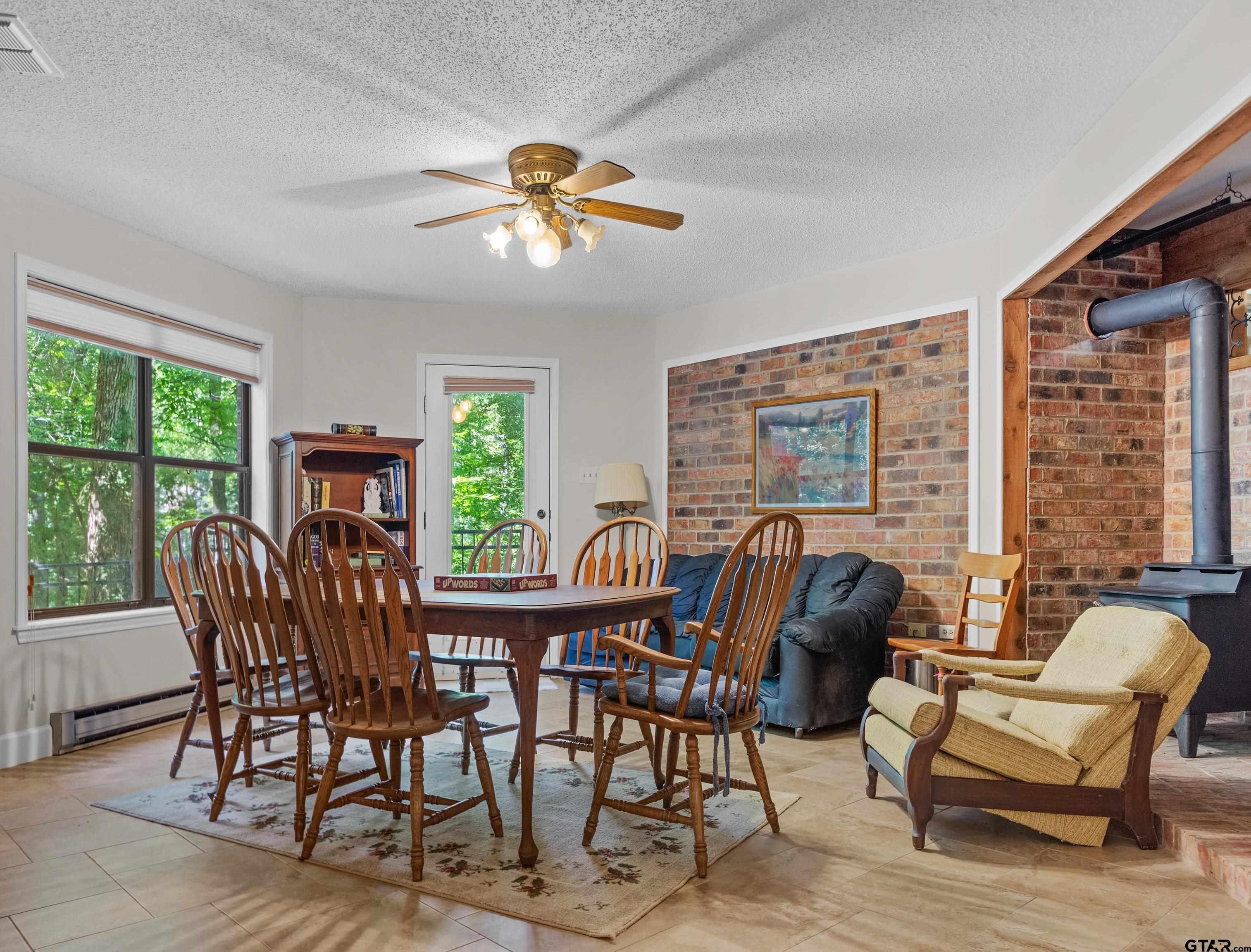 18862 Big Timber Road Tyler, TX 75703 - Photo 24 of 33 a dining room with furniture a chandelier and wooden floor