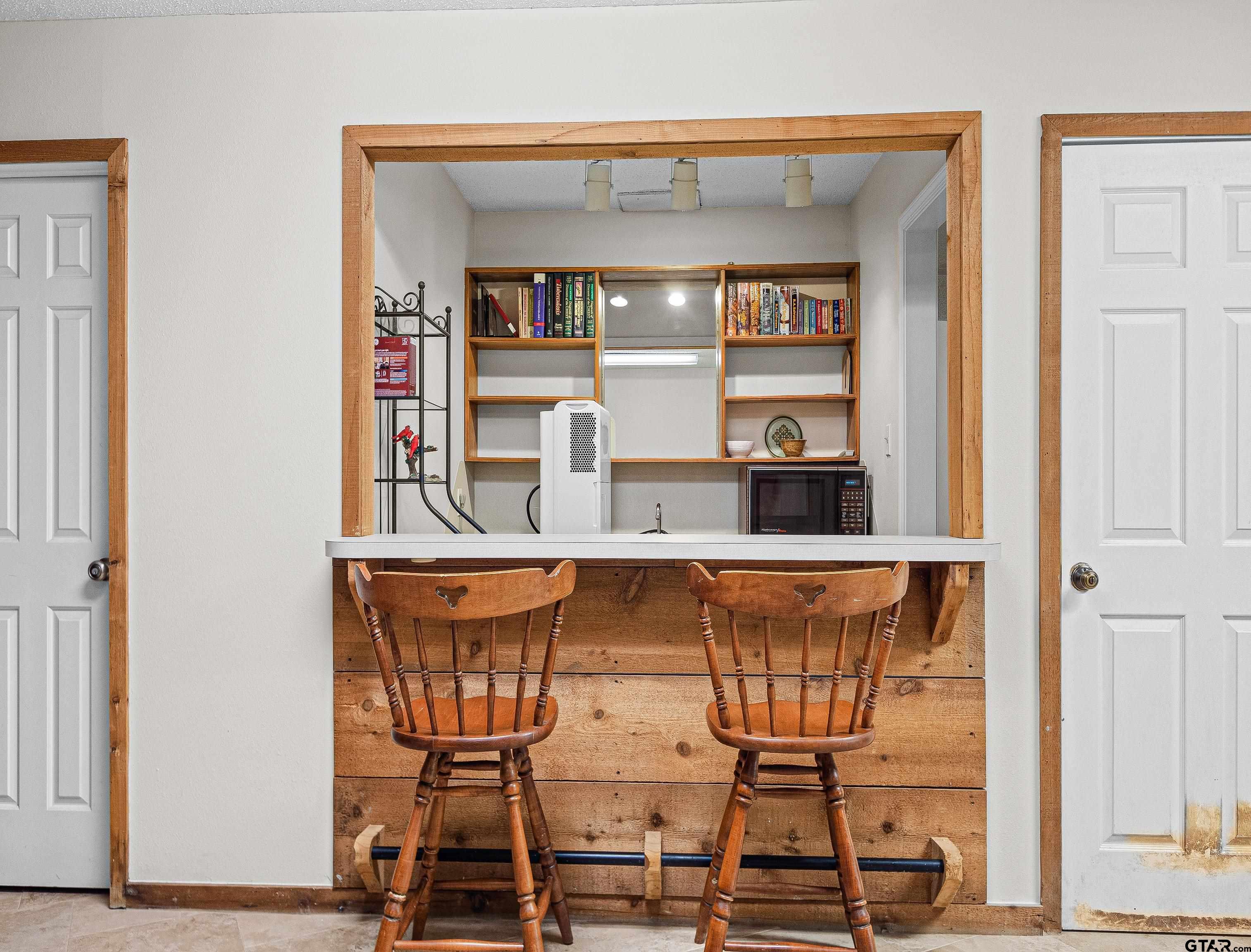18862 Big Timber Road Tyler, TX 75703 - Photo 26 of 33 a view of a dining room with furniture and wooden floor
