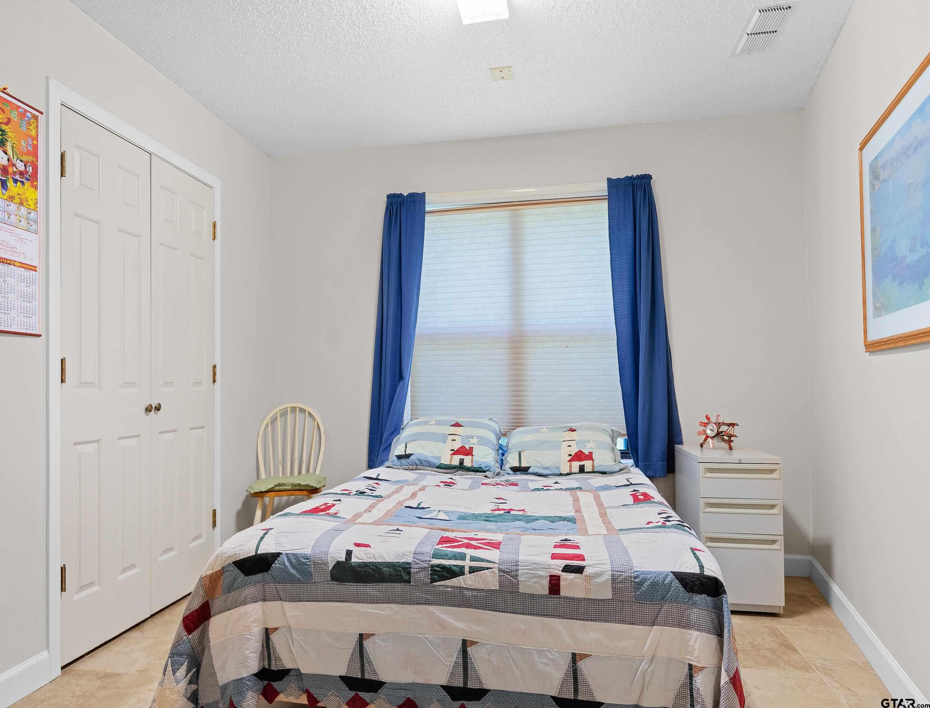 18862 Big Timber Road Tyler, TX 75703 - Photo 28 of 33 a bedroom with a bed and a window