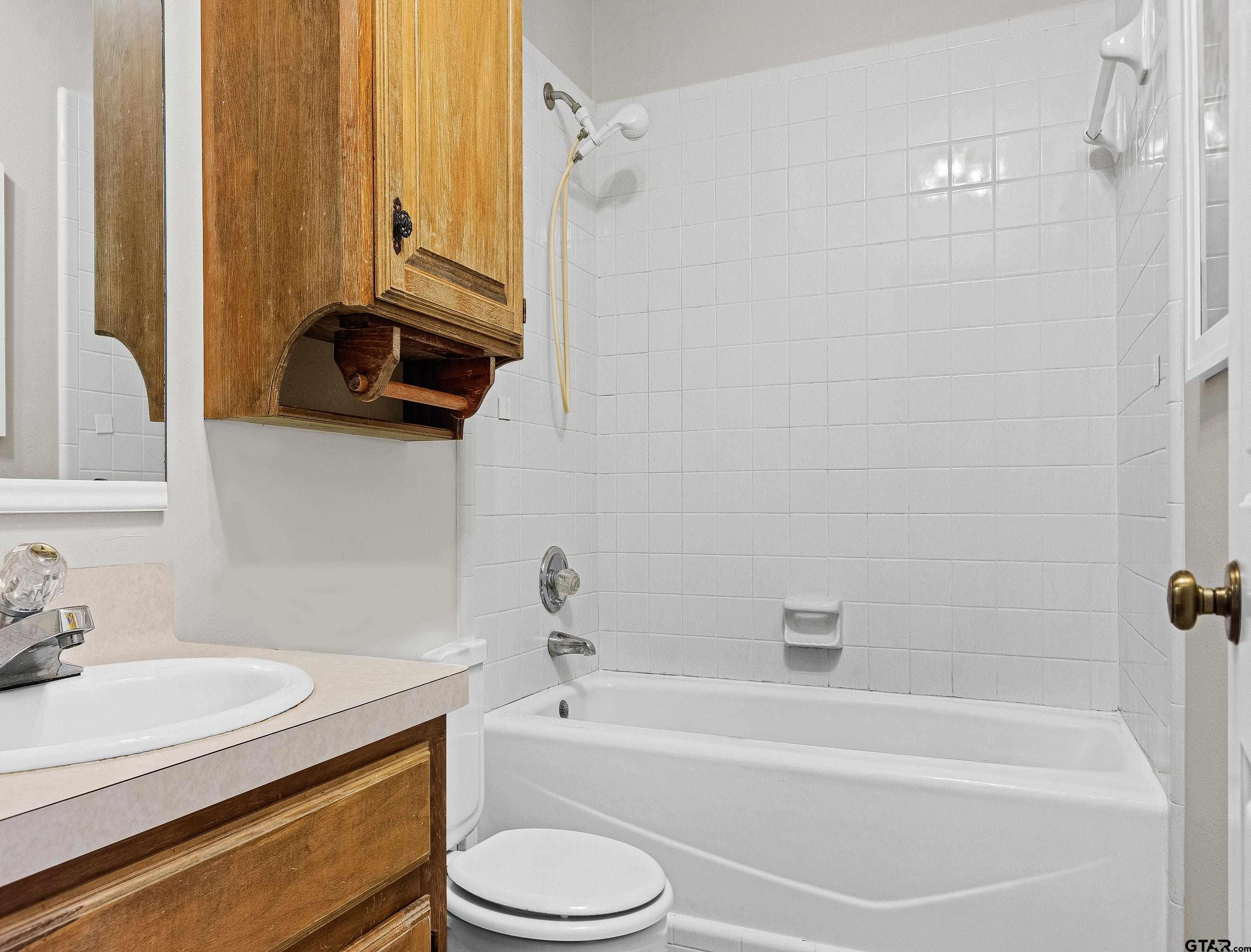 18862 Big Timber Road Tyler, TX 75703 - Photo 29 of 33 a bathroom with a sink a toilet and a bathtub