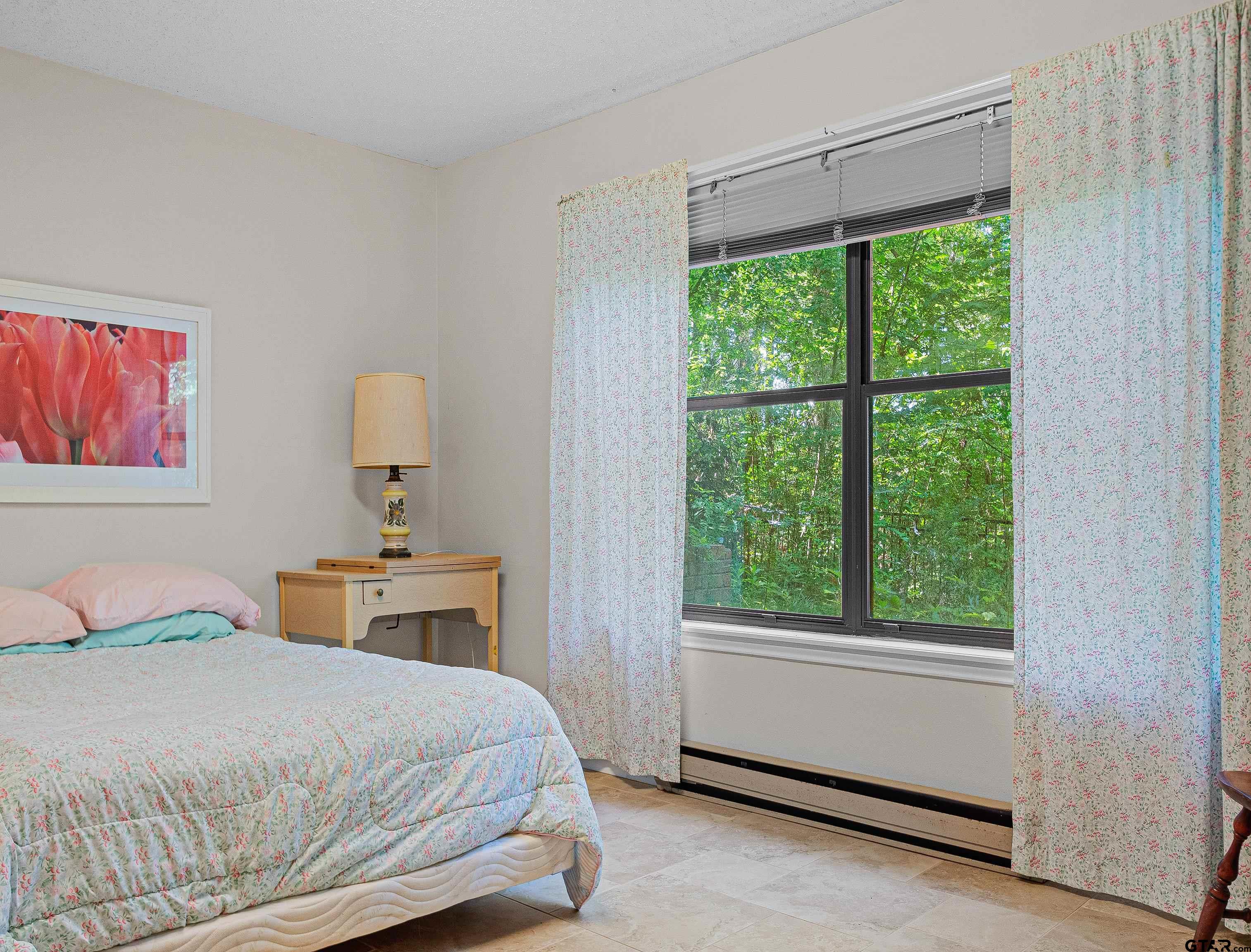 18862 Big Timber Road Tyler, TX 75703 - Photo 30 of 33 a bedroom with a bed and a window