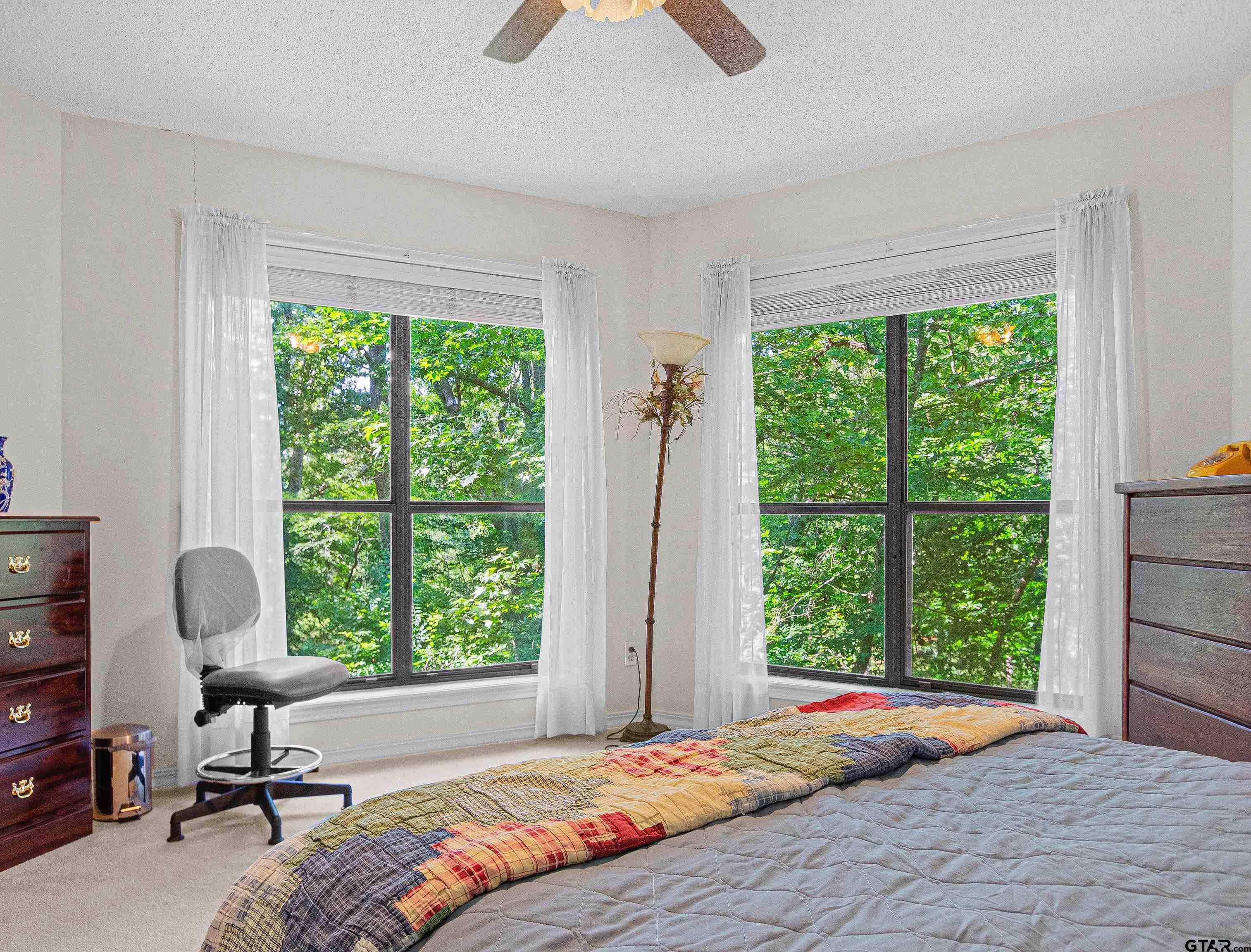 18862 Big Timber Road Tyler, TX 75703 - Photo 31 of 33 a bedroom with a bed a large window and outside view